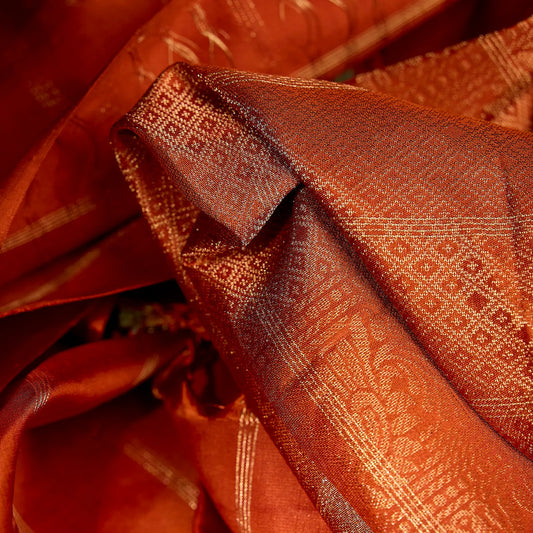 Aarunya burnt orange Kanchivaram silk saree with gold zari geometric patterns and elegant tassels – festive saree UAE