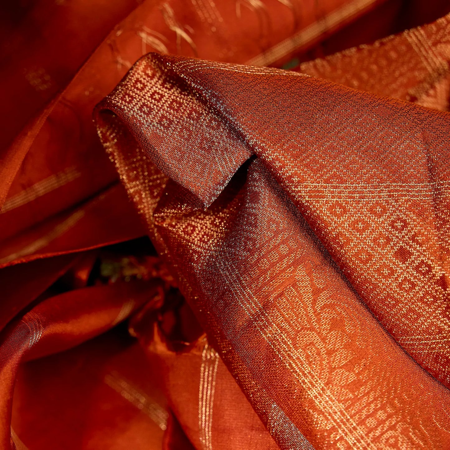 Aarunya burnt orange Kanchivaram silk saree with gold zari geometric patterns and elegant tassels – festive saree UAE