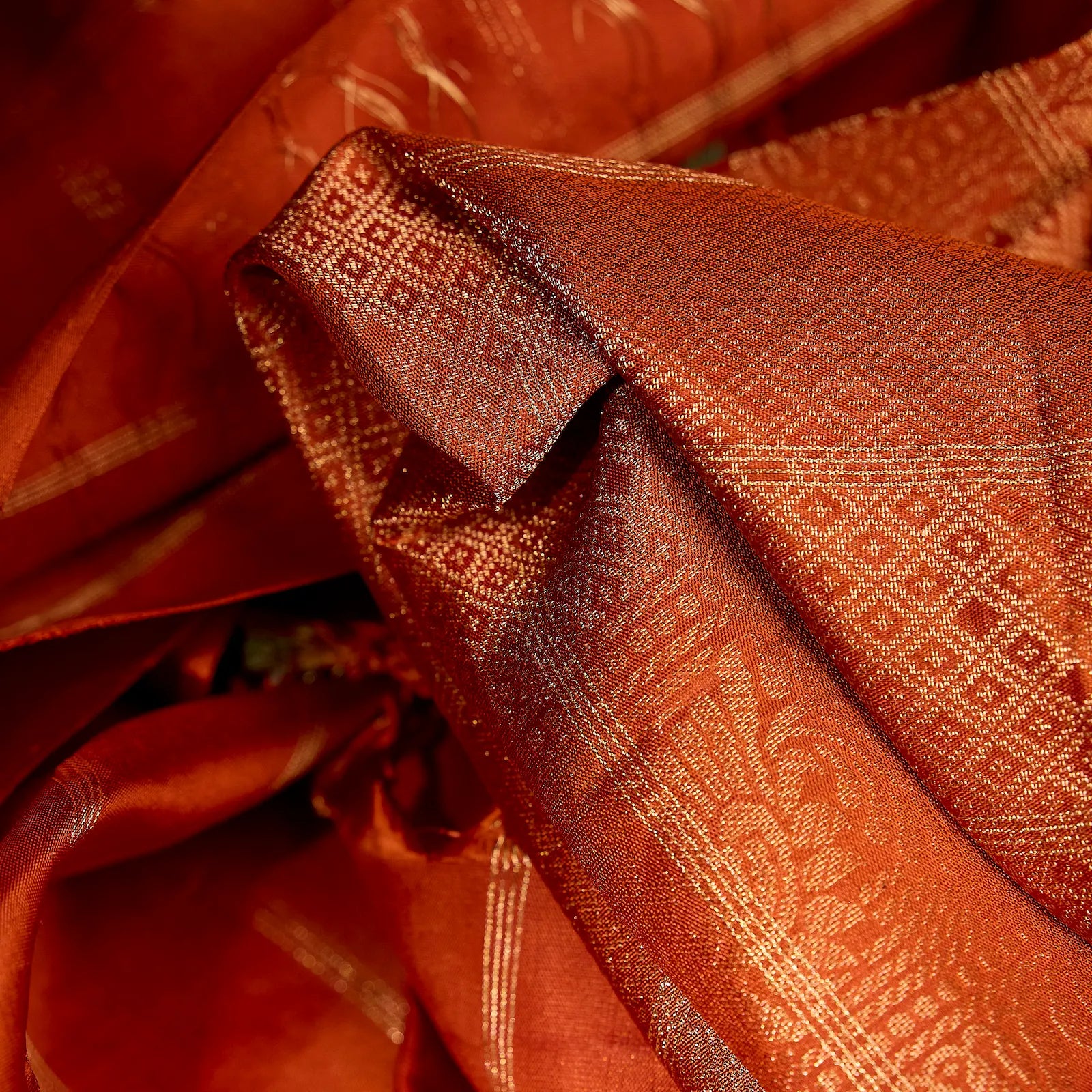 Aarunya burnt orange Kanchivaram silk saree with gold zari geometric patterns and elegant tassels – festive saree UAE