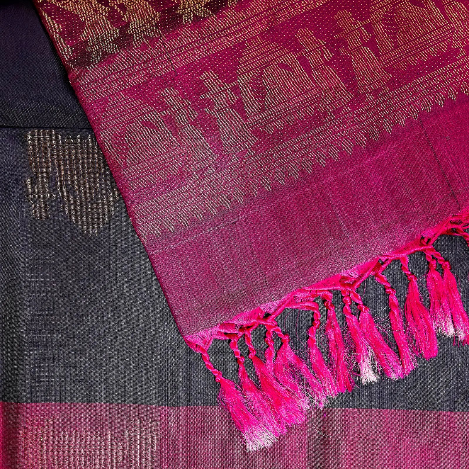 Paalki black and rani pink Kanchivaram silk saree with palanquin-inspired antique gold zari motifs and tassel detailing – bridal saree UAE