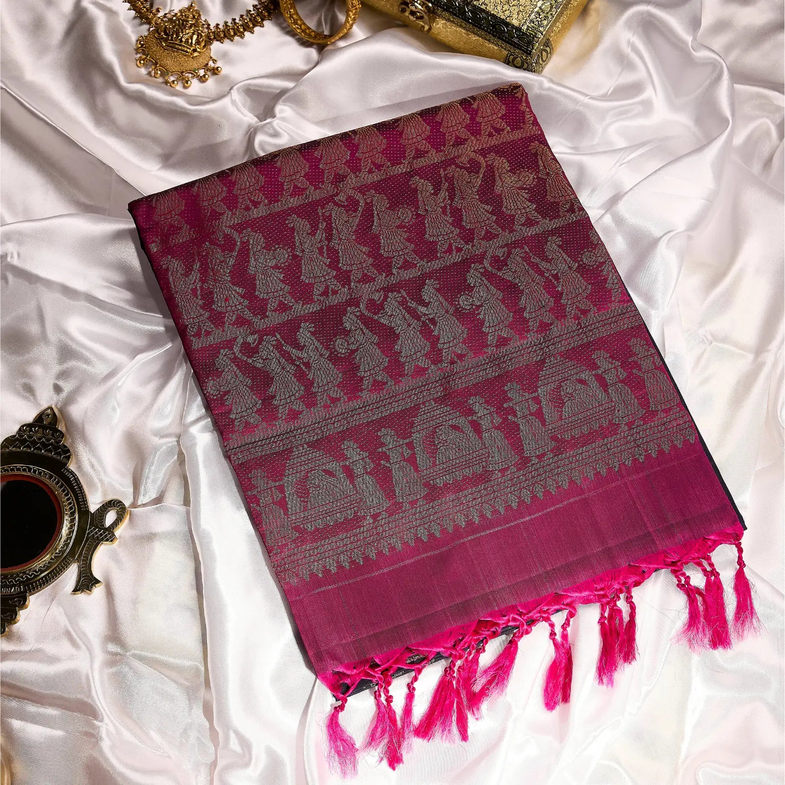 Paalki black and rani pink Kanchivaram silk saree with palanquin-inspired antique gold zari motifs and tassel detailing – bridal saree UAE