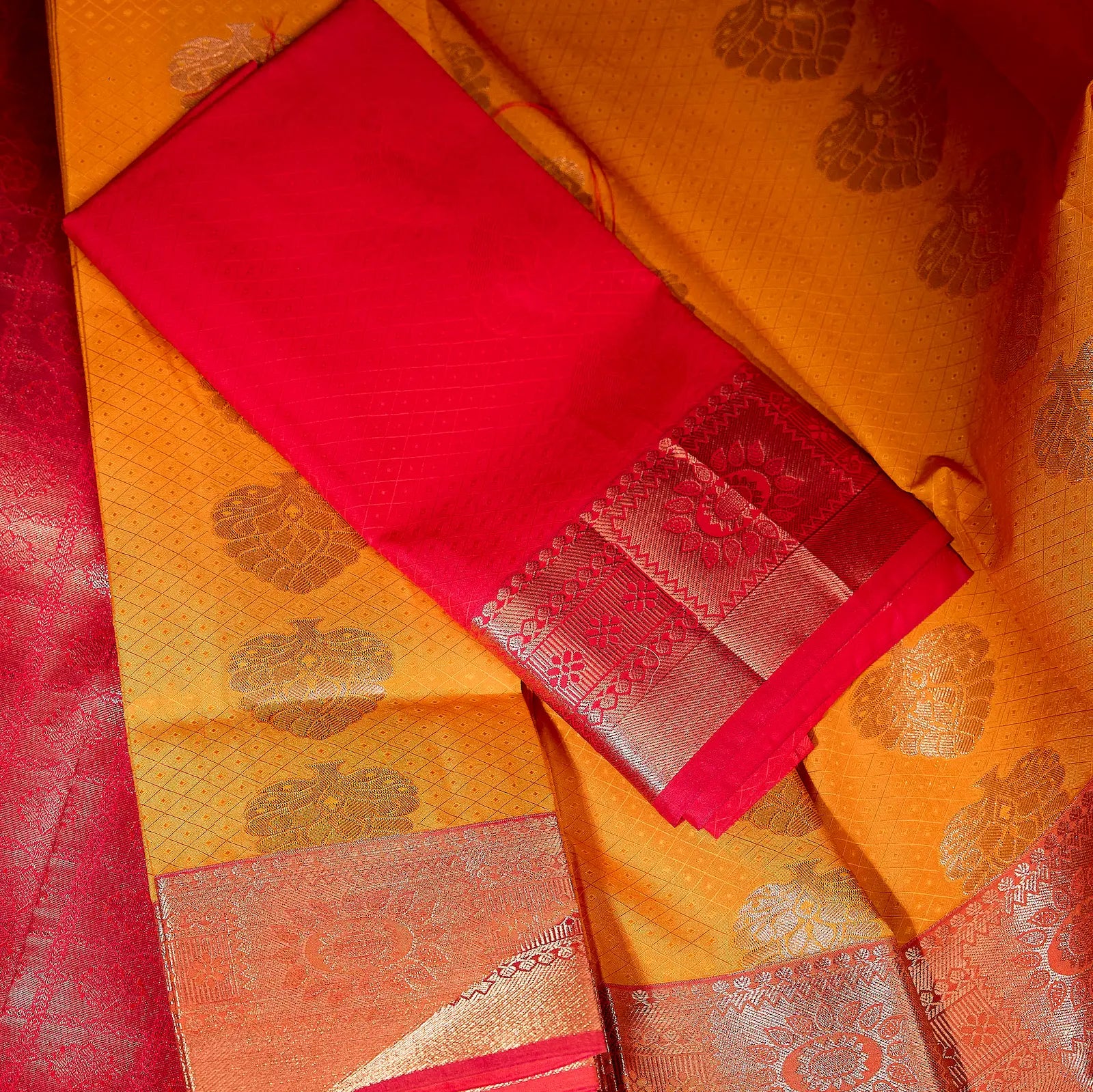 Kesari Varnika amber gold and rani pink Kanchivaram silk saree with floral zari motifs and tassel accents – festive saree UAE