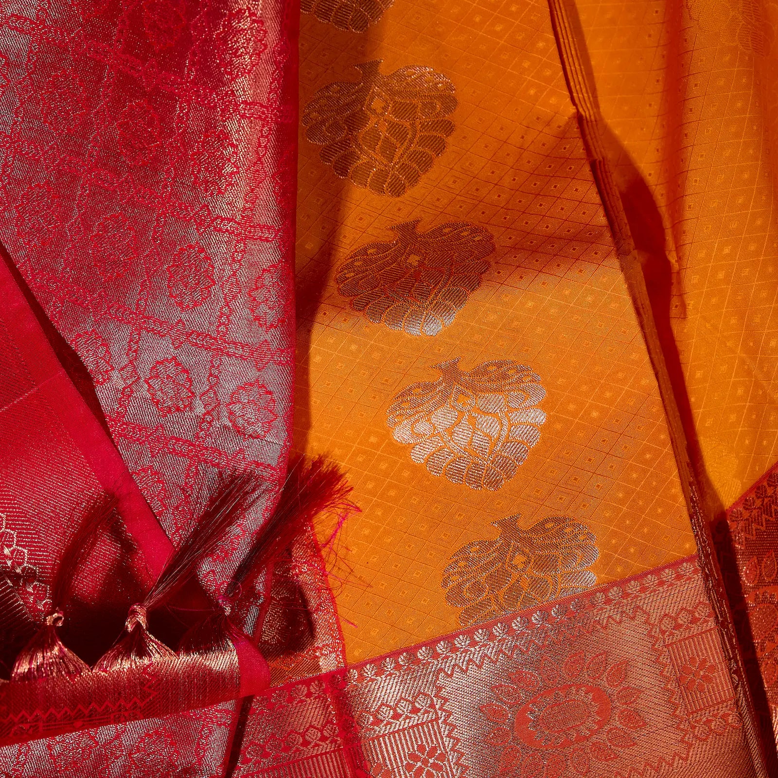 Kesari Varnika amber gold and rani pink Kanchivaram silk saree with floral zari motifs and tassel accents – festive saree UAE