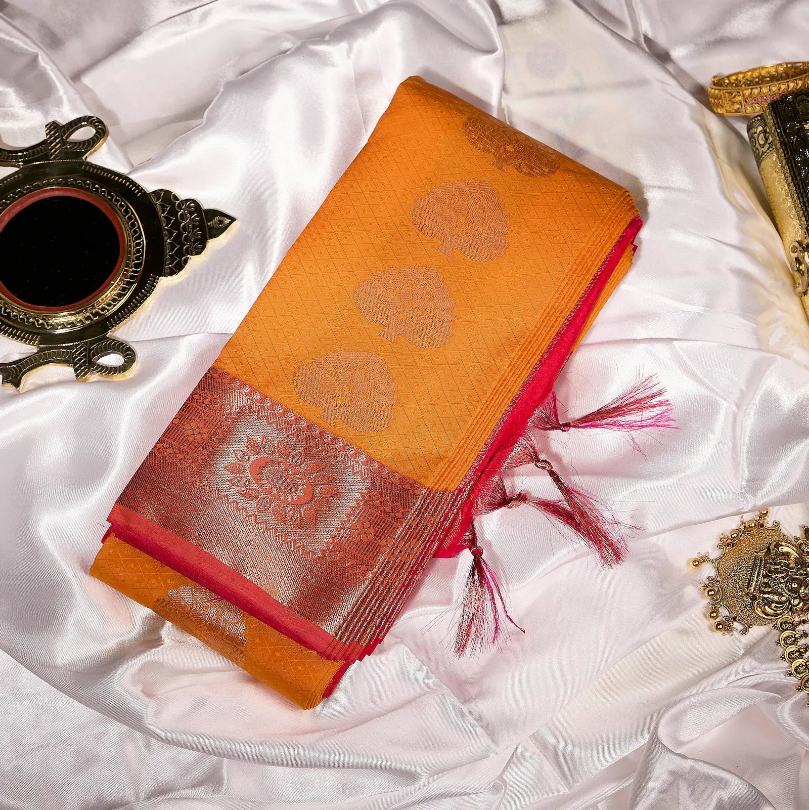 Kesari Varnika amber gold and rani pink Kanchivaram silk saree with floral zari motifs and tassel accents – festive saree UAE